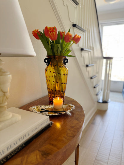 Vase with flowers on a wooden table in a home setting